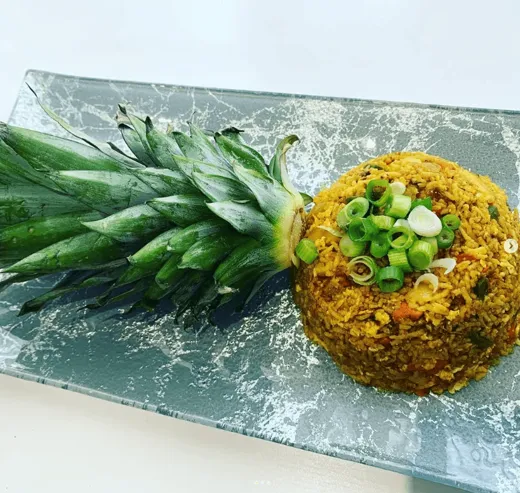 Pineapple fried rice, served in the halved pineapple
